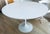 Authentic Tulip table designed by Eero Saarinen for Knoll in 1956. Round 42" wood and white laminate top on white enameled...