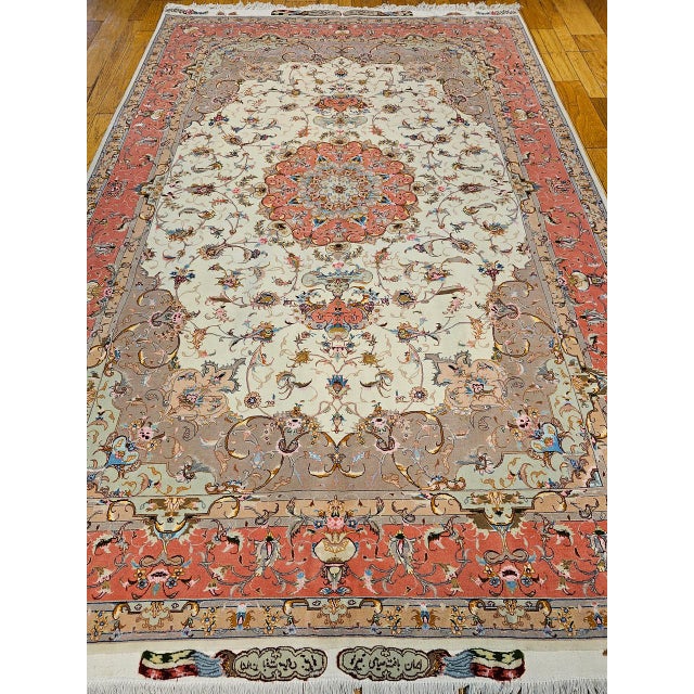 "A late 20th century Persian Tabriz room size rug in a floral pattern. This beautiful rug features a classic floral...