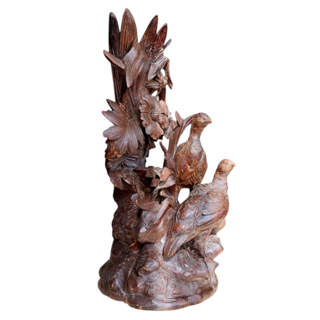 A beautiful antique Black Forest vase, richly decorated with flowers and four elegant birds. Four of the leaves have been...