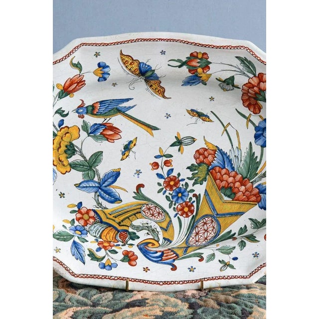 This 18th-century French faience serving dish from Rouen features an exquisite polychrome decor of two cornucopias filled...