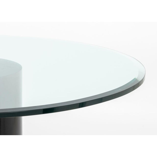 Modern Glass Top Pedestal Table, the circular beveled glass top above cylindrical black patinated metal base. 29.25" H x...