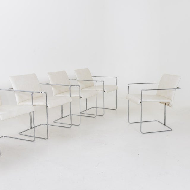 Set of six Modernist dining chairs by Ernesto Radaelli. Chrome plated steel frames and leather upholstered seats.