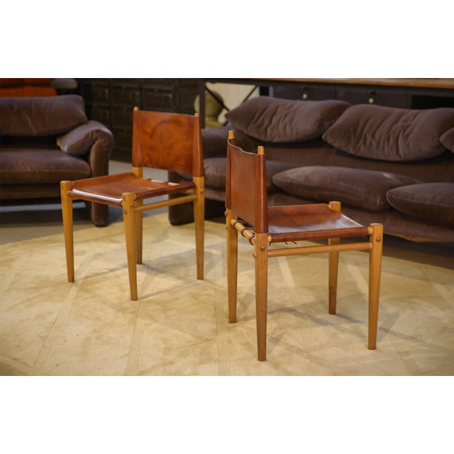 A wooden frame with slender lines, reminiscent of an architect's work: straight uprights, exposed crossbars, and light...