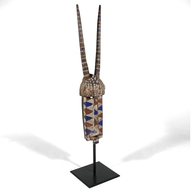 This large and powerful carved Molo mask by the Bobo people from Burkina Faso is in the form of an antelope. Covered in...