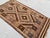 A small handwoven Maimana kilim from northern Afghanistan, worked on a deep chocolate ground with camel, slate blue,...