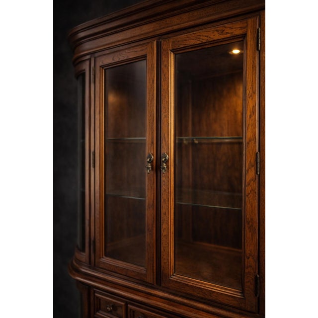 Chocolate Large Mid-20th Century Colonial Revival Oak China Cabinet With Curved Glass Display Ends & Interior Lighting — Two-Piece Hutch For Sale - Image 8 of 11