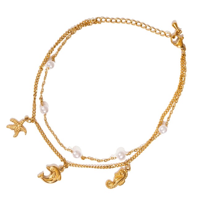 Bring the spirit of the ocean to your style with the Ocean Dreams Gold Double Chain Anklet. This unique handmade anklet...