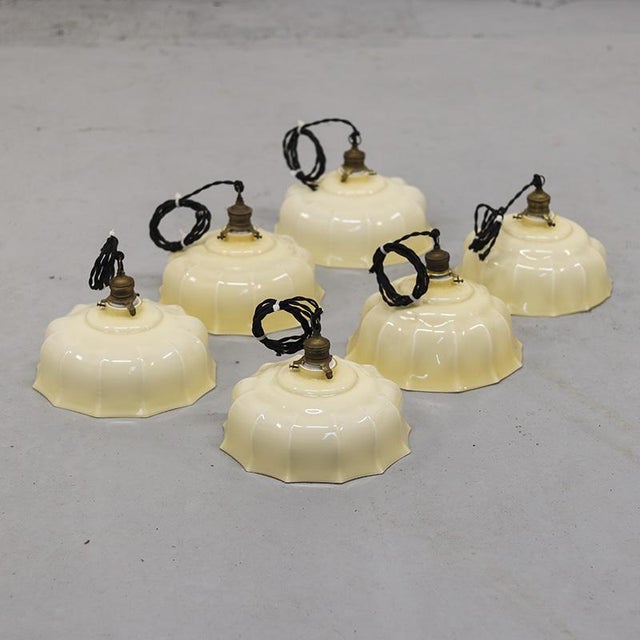 Extremely decorative Art-Deco hanging lamps from the 1930s with beige opaline glass. The lamps have a decorative shade...