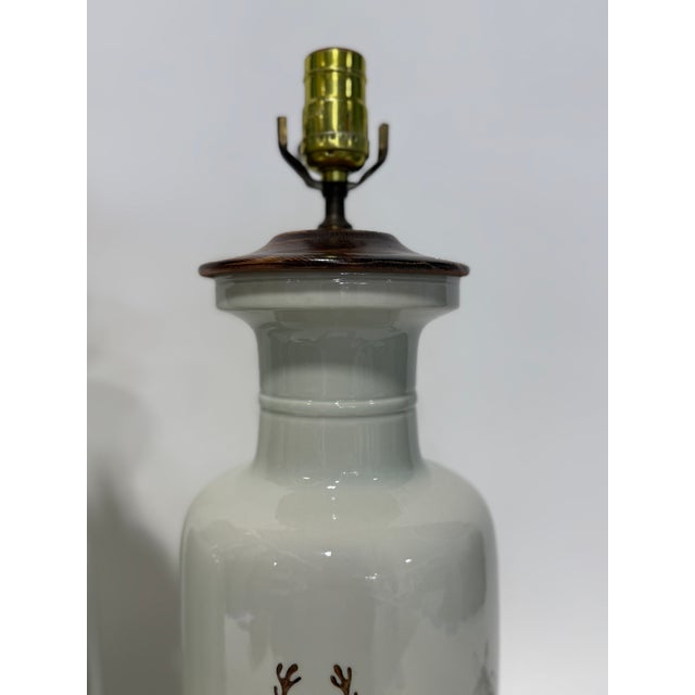 A refined and thoughtfully composed near pair of Chinese export style armorial porcelain table lamps, custom mounted by...
