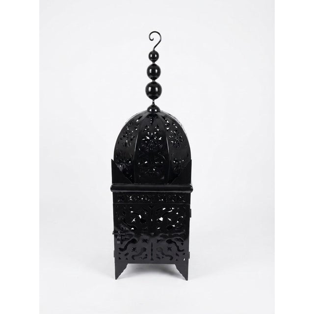 This Moroccan lantern is handmade in Marrakech from pierced iron and finished in a dark aged tone, with colors ranging...