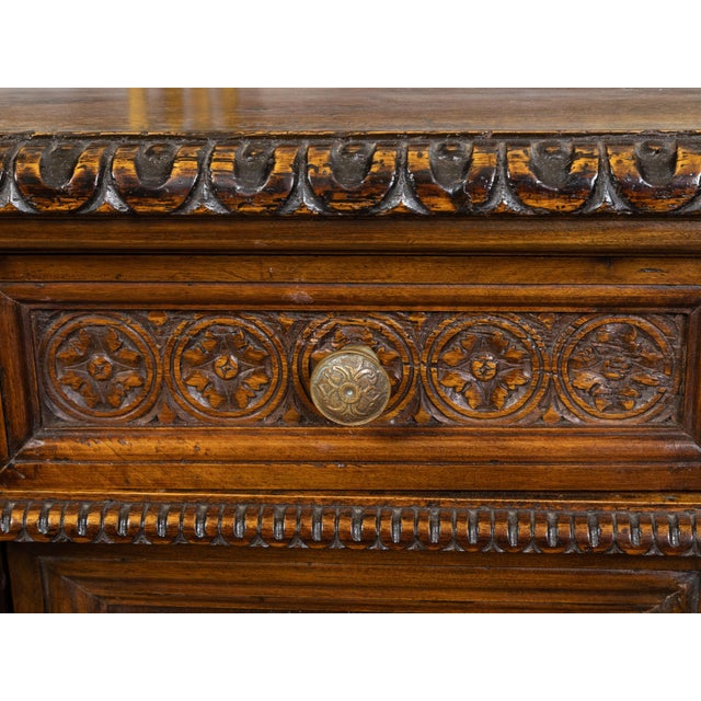 An Italian walnut small cabinet from the early 19th century, with single drawer over single door, carved foliage, vase and...