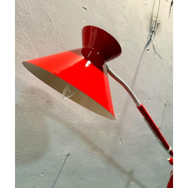 1970s-style adjustable floor lamp with a minimalist design and striking aesthetic. Wooden frame with a stable base, long,...