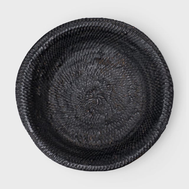 This small woven tray from the early 20th century celebrates the beautiful simplicity of a hand-woven object. The round...