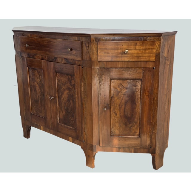 We offer this important Italian sideboard, crafted in the very early 19th century, a striking piece that combines...