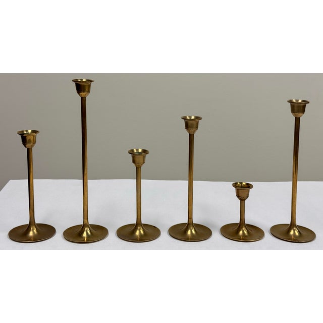 Set of six (6) vintage mid century modern tulip brass candlesticks of ascending height. Shortest 3"H, tallest 8.75"H....