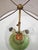 This vintage table lamp stands out for its rounded, sculptural base in veined green marble-effect ceramic, enhanced by...