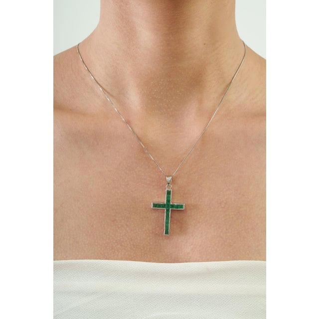 The Contemporary 2.17 Ct Natural Emerald Channel-Set Cross Pendant features a clean cross silhouette accented with 2.17...
