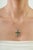 The Contemporary 2.17 Ct Natural Emerald Channel-Set Cross Pendant features a clean cross silhouette accented with 2.17...