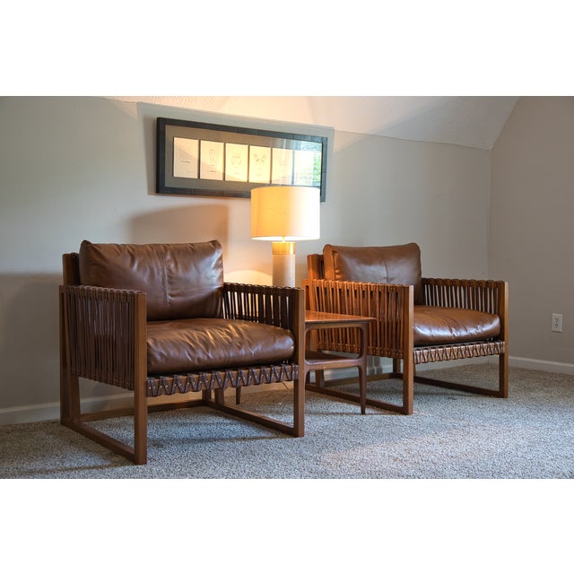 A sculptural silhouette meets rich texture in this statement-making chair. Wrapped in supple chestnut leather and accented...
