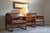 A sculptural silhouette meets rich texture in this statement-making chair. Wrapped in supple chestnut leather and accented...