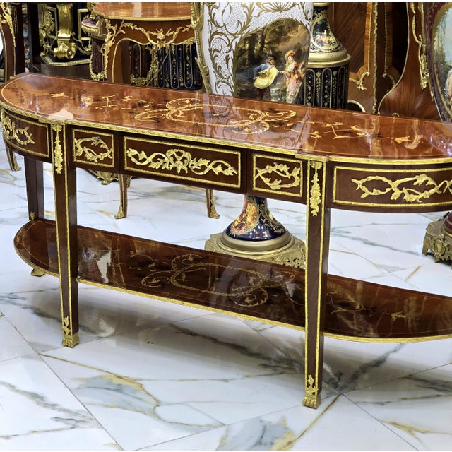 A refined Louis XVI–style coffee table or console, elegantly embellished with exquisite gilt bronze mounts and genuine...