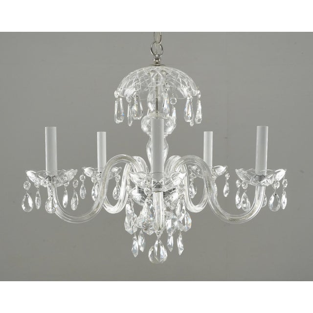 Traditional style chandelier with faceted teardrop crystals and polished nickel hardware. The chain is made of steel, and...