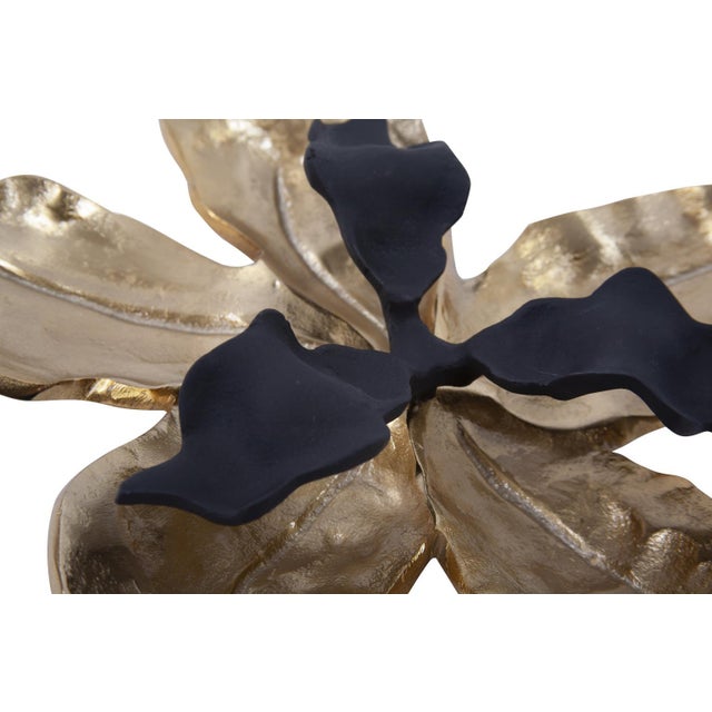 Hand finished in bright gold and matte black this tropical orchid flower will bring a sense of whimsy to a tabletop or as...