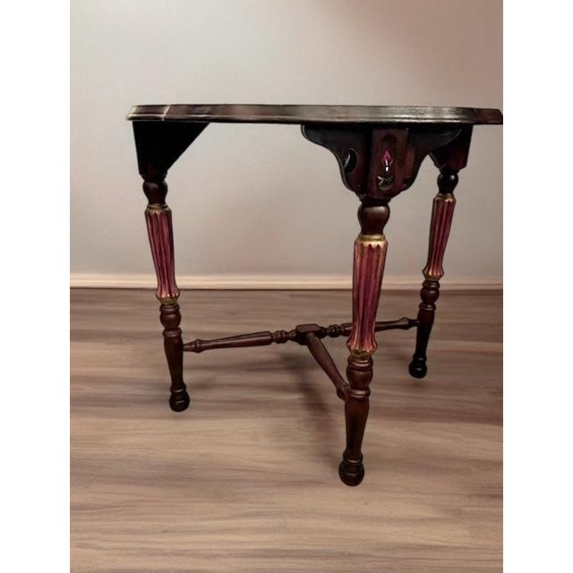 This one-of-a-kind demi-lune console table features a beautifully painted design in rich burgundy, blush pink, and soft...