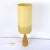 This elegantly shaped lamp foot has a slim waist and carries a soft yellow conic shade of which the bottom part is set...