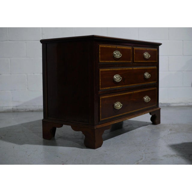 This Early 20th Century American Federal Style Inlaid Mahogany Chest showcases timeless craftsmanship and elegance....