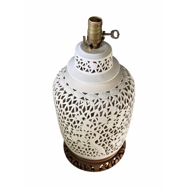 Elevate your interior decor with this exquisite pair of vintage blanc de chine ceramic table lamps. Each lamp features an...