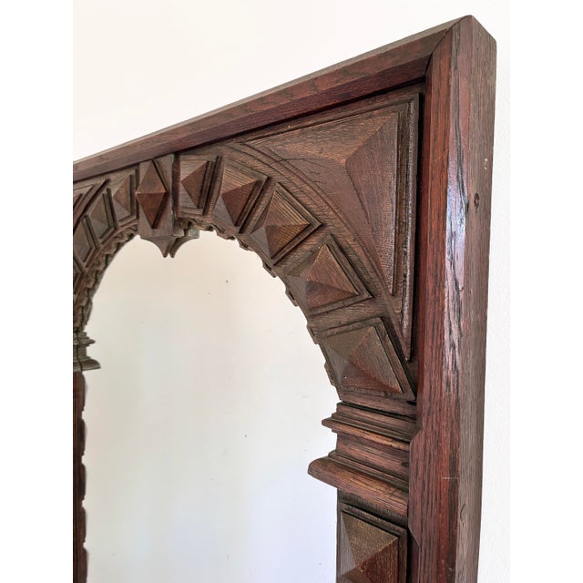 Antique Spanish Revival wall mirror, dating from the 1920s. This is a heavy and robust oak mirror with a dark finish, a...
