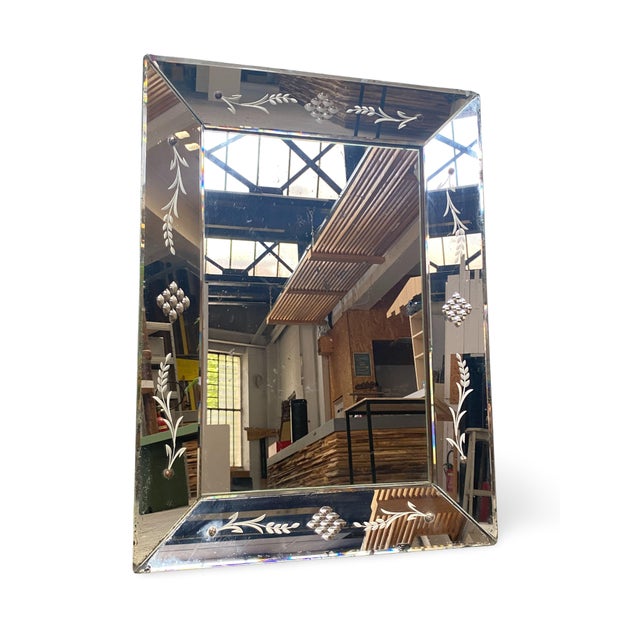 Rectangular Venetian mirror with a central beveled glass panel, framed by a border of engraved beveled glass panels...