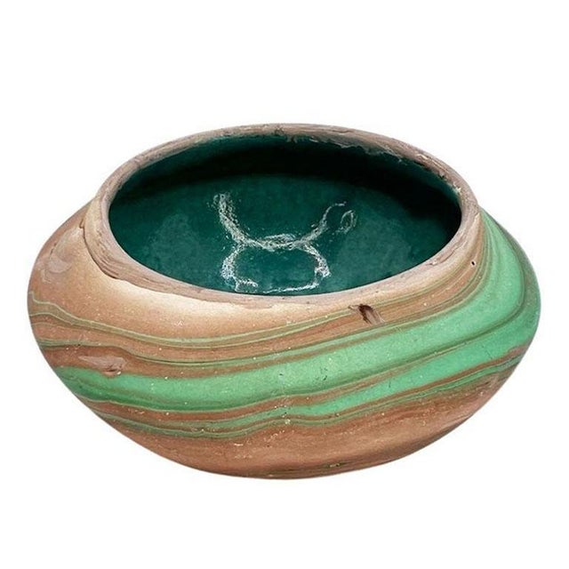 A petite small clay roadside decorative touring bowl. This catchall or dish is short, and wide, and decorated with a...
