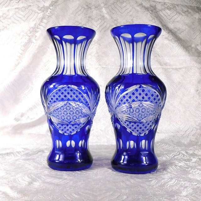 This is a pair of two blue cut to clear vases. They are an exact match except for one detail-the middle section of cuts...