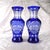 This is a pair of two blue cut to clear vases. They are an exact match except for one detail-the middle section of cuts...