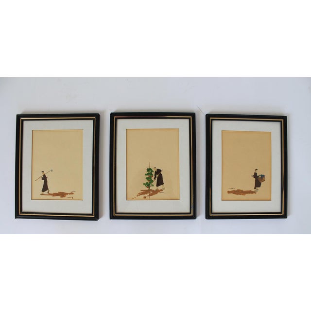 Set of three framed minimalist (I believe) watercolor painting of a man working and harvesting from his garden. Each is...