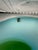 Venini plate from the Coreani series, transparent in color with overlapping spiral bands of blue and apple green. The...