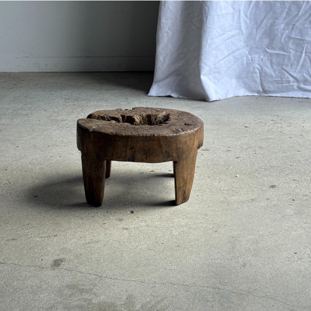 Small, low, circular, four-legged stool in reclaimed, organically carved teak. Antique Indonesian village furniture. Ideal...