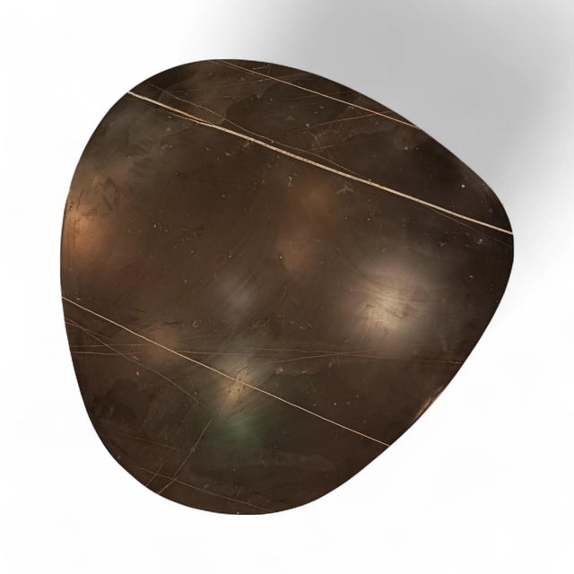 Elegant low coffee table with an organically rounded Bamboo marble top and a sculptural Carrara marble base. A...