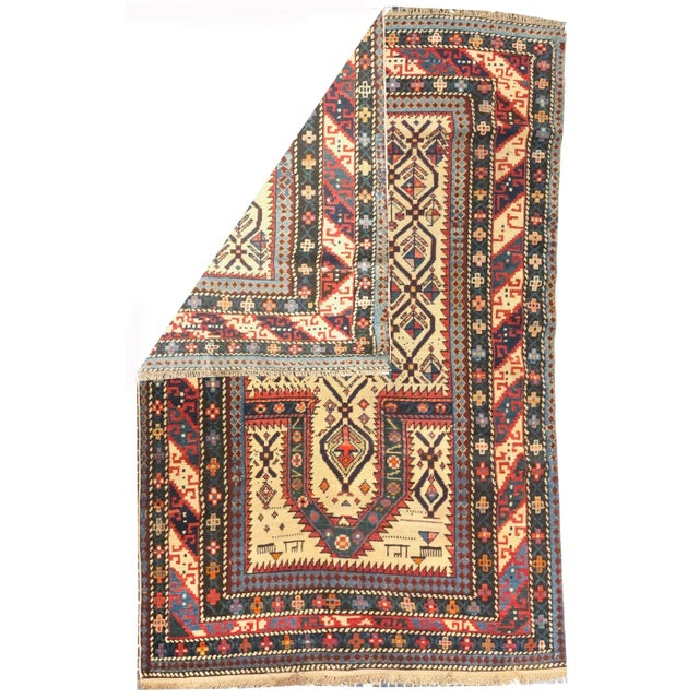 The narrow ecru field displays a lozenge lattice enclosing a one-way floral pattern, with animals in the spandrels....