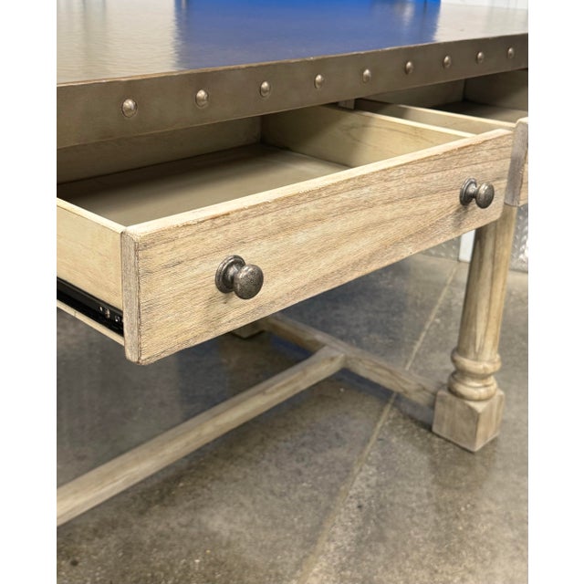 A burnished stainless top and decorative nailhead trim surround the top edge of the bistro tables or a floating kitchen...