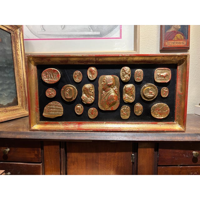 Rich arrangement with classical gilded plaster cameos representing classical characters, emperors and architectural and...