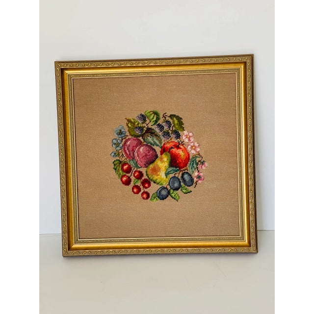 Vintage handcrafted needlepoint still life on beige background, framed in gold tone frame. Neoclassical wall decor.