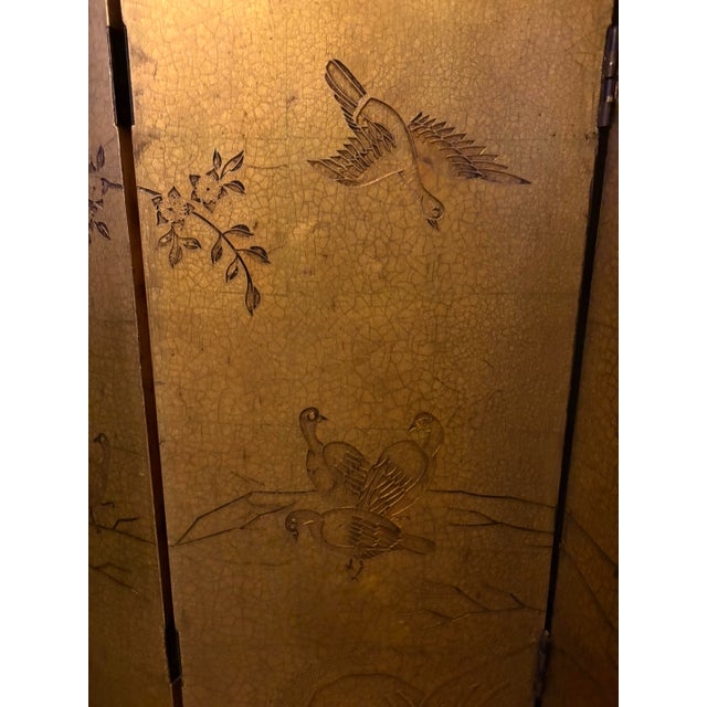 Exquisite antique hand-carved four-panel golden screen constructed from lacquered wooden panels with gold leaf, as well as...