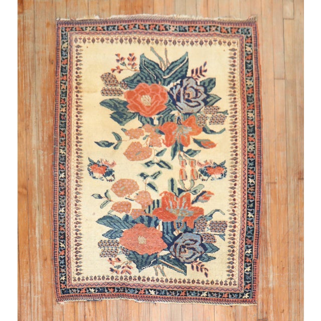 An early 20th century Persian Afshar Tribal rug with a large floral design on an ivory field Measure: 3'9'' x 4'10''.