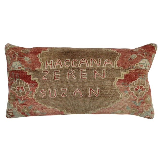 Pillow made from an early 20th-century Turkish rug in brown and soft red with the name 2 first names and last name of a...