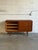 This exceptional sideboard features a clean rectangular profile with smooth sliding doors. The dual-sectioned interior...