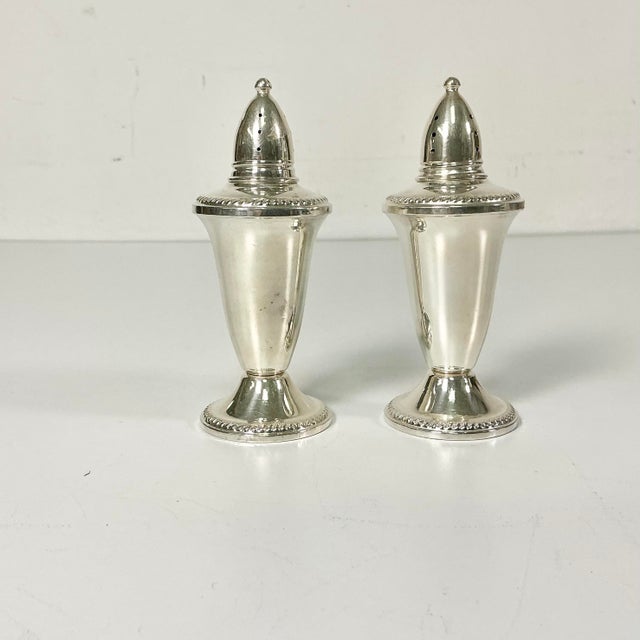 A lovely set of weighted Sterling Silver Salt and Pepper Shakers. They have glass liners and rope edges along the bottom...