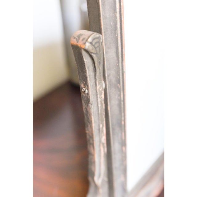 An Art Deco tilting photo frame in painted wood with a distressed silver-gray finish, the warm rose-toned underlayer worn...